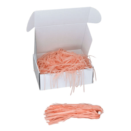 Peach  tissue shred filler displayed in a white gift box